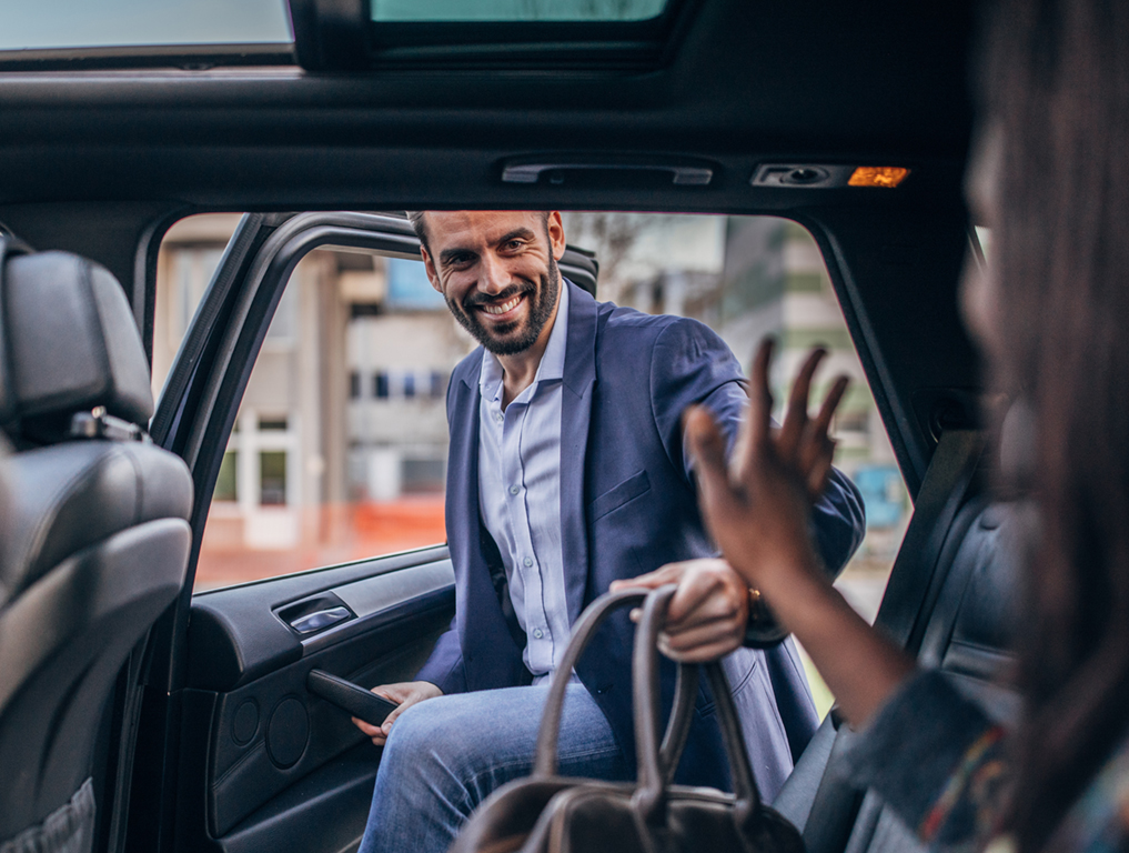 man entering back seat of car