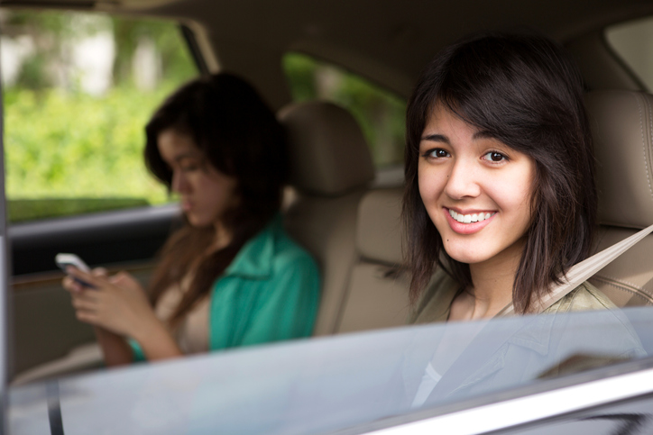 teenage passengers in back seat of car